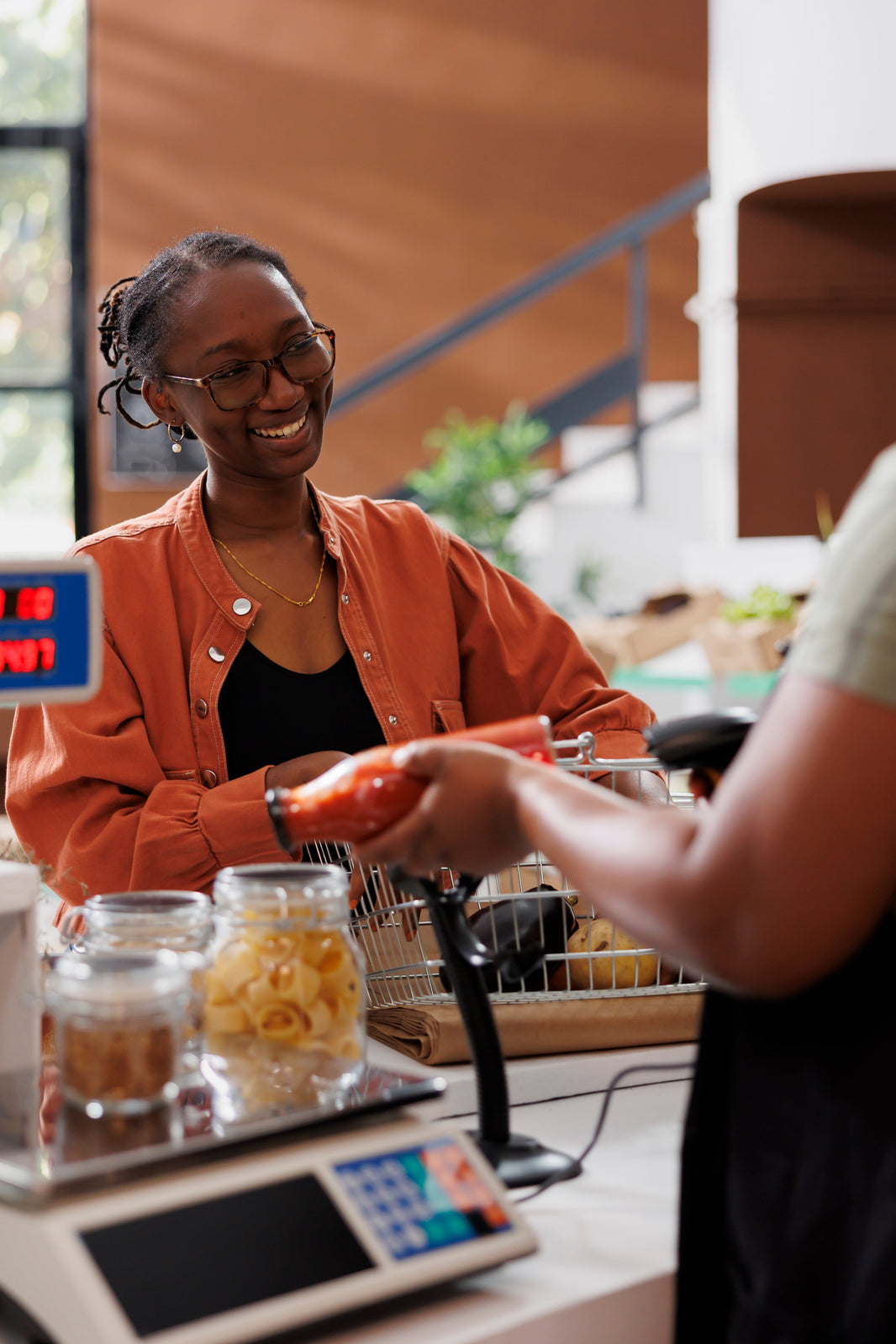 smiling woman checking out groceries
