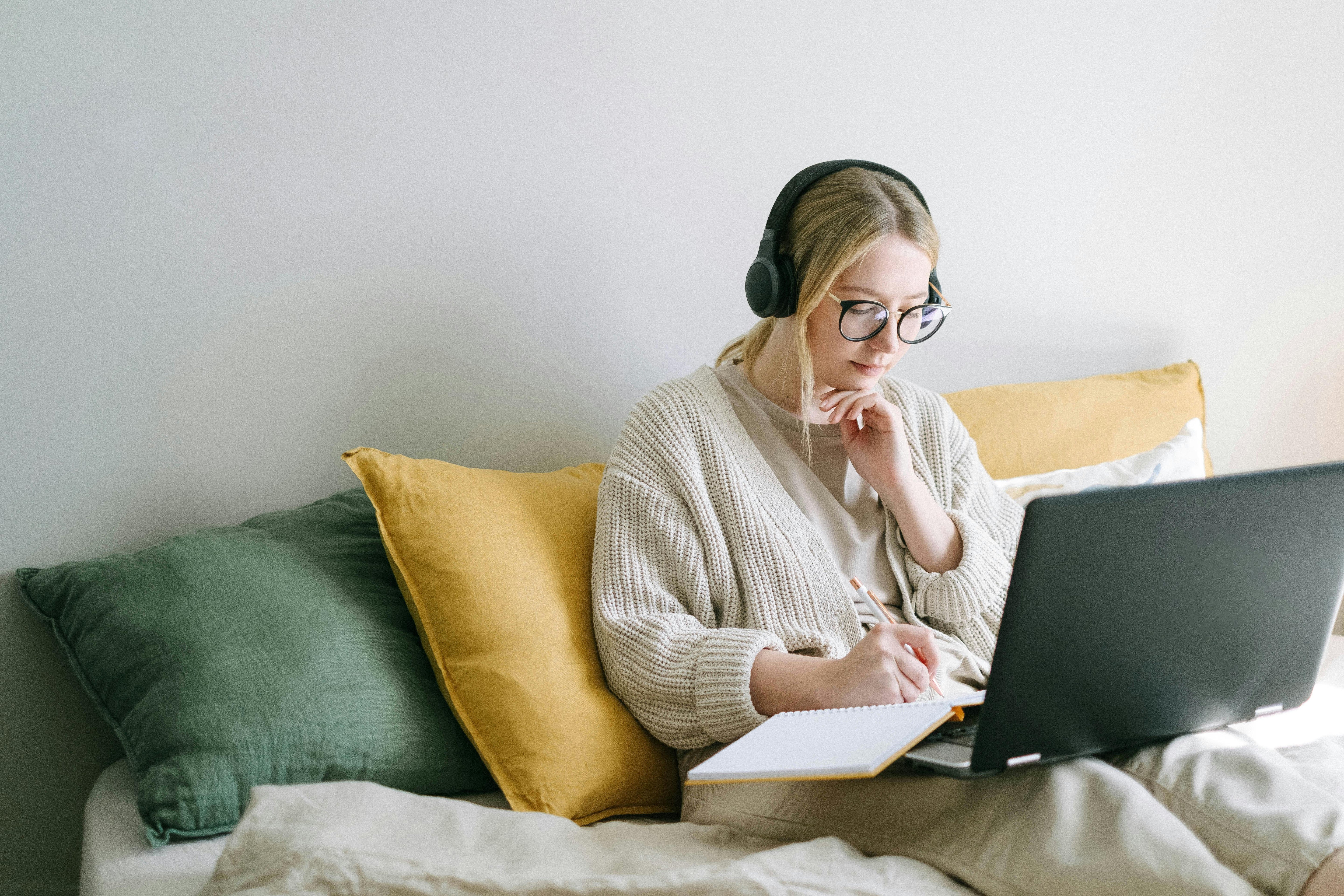 woman wearing headphones studying