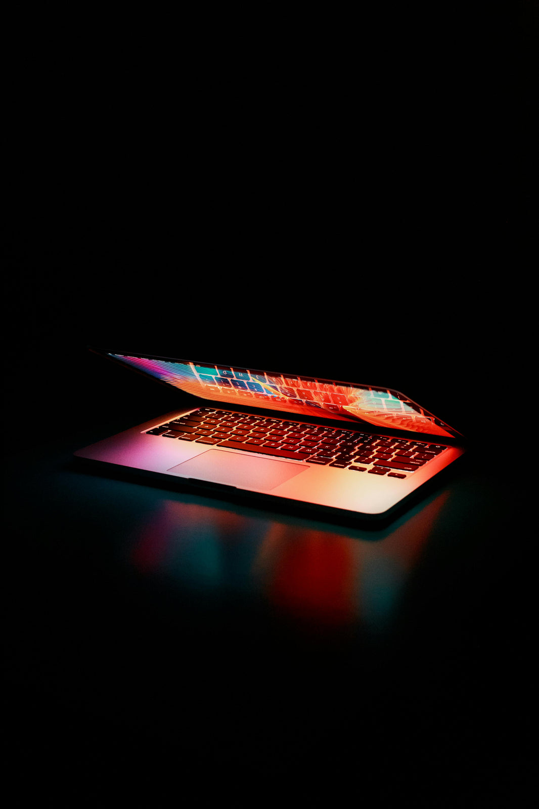 glowing laptop on black background