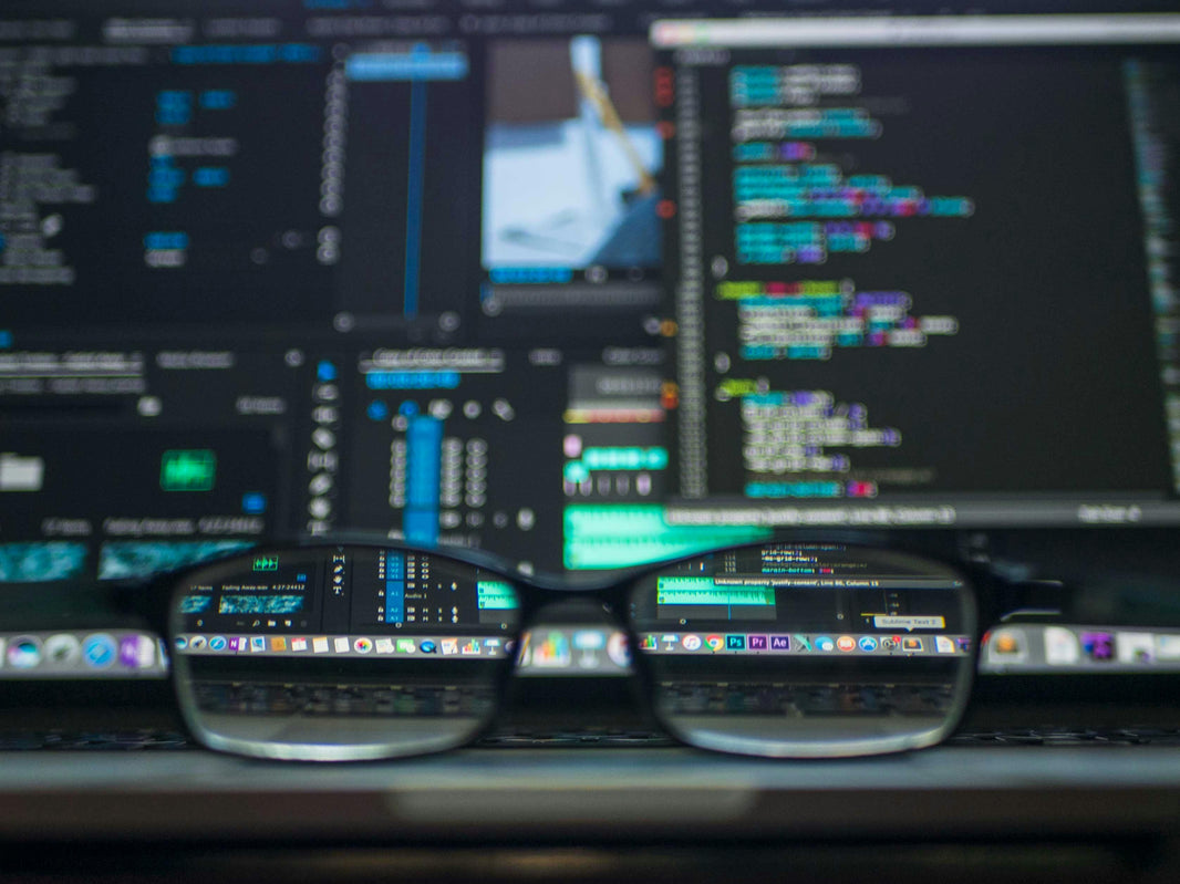 pair of glasses on computer keyboard