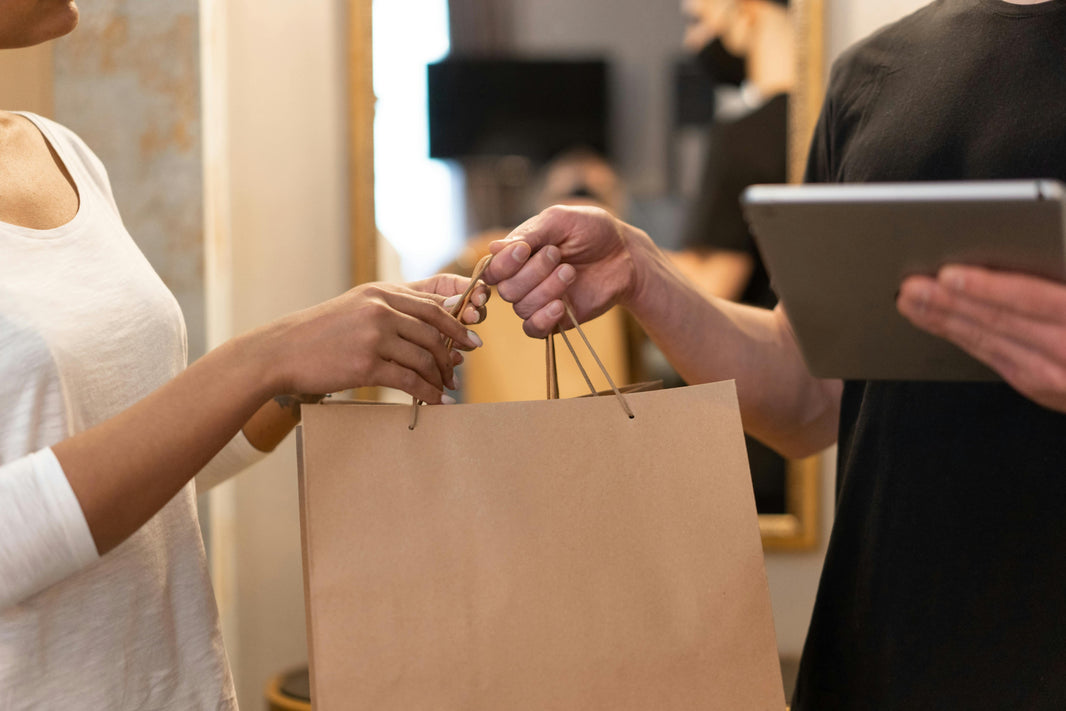 employee handing bag to customer