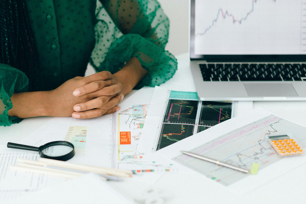 woman sitting with notes on a desk