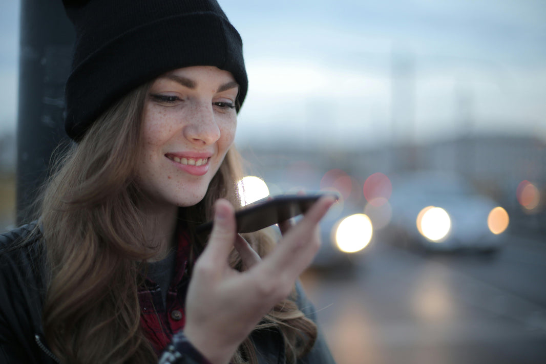 woman speaking into smart phone