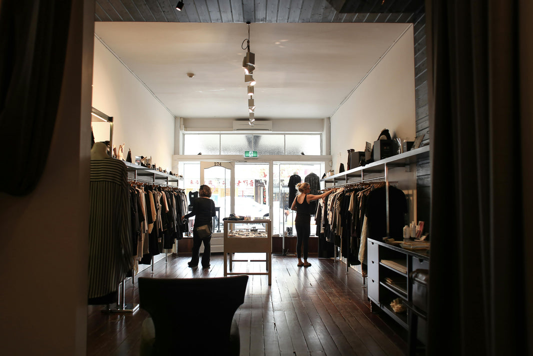 multiple people browsing a clothing store