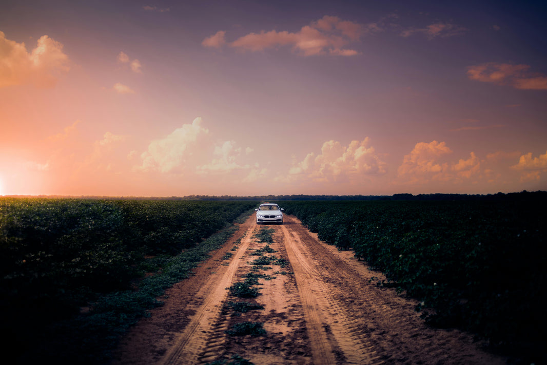 lone car driving on an empty road