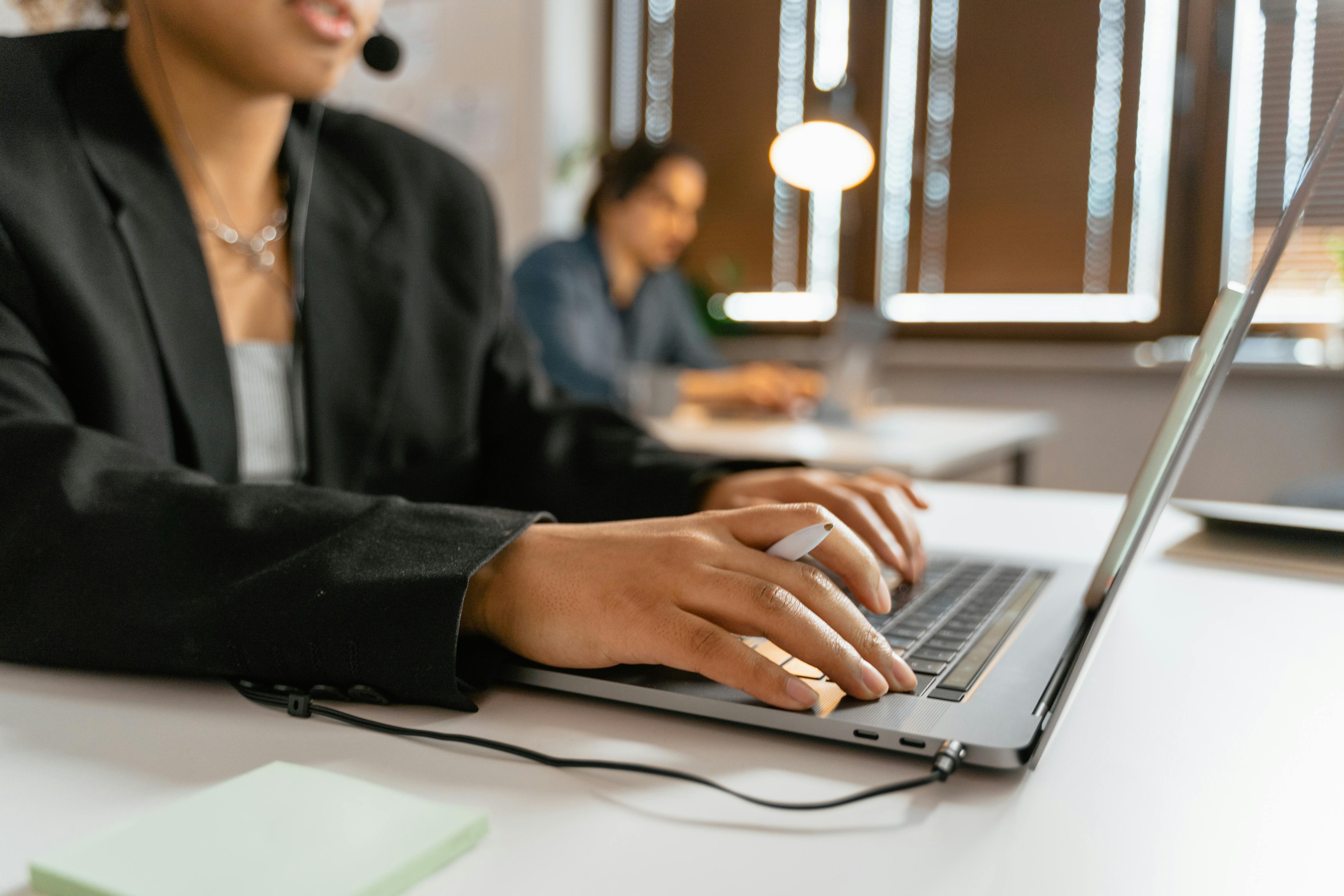 woman in suit typing on computer