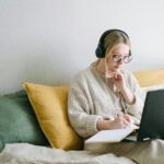 woman wearing headphones studying