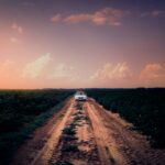 lone car driving on an empty road