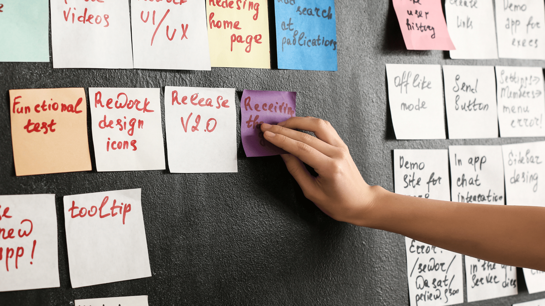 placing sticky notes on blackboard