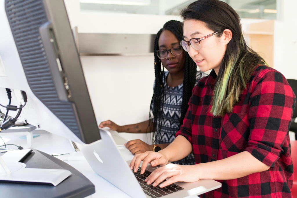 two employees working on laptop