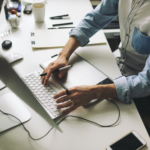 man typing on computer