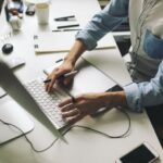 man typing on computer