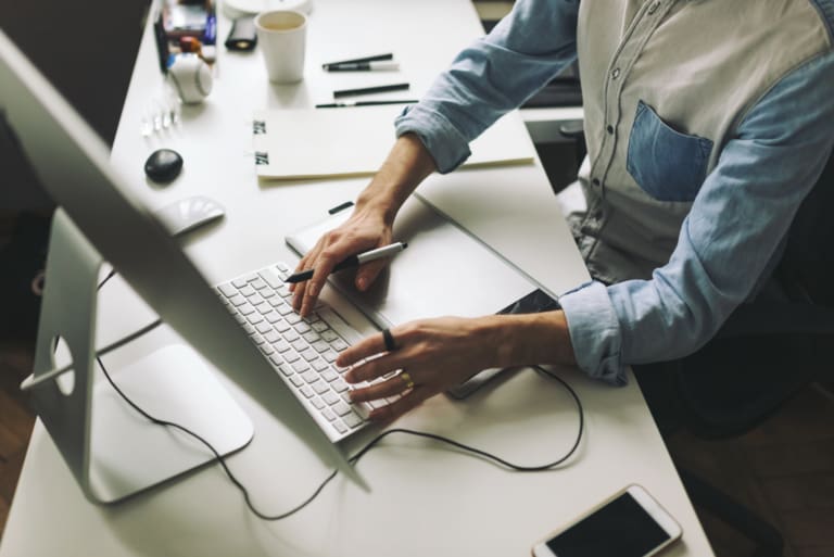 man typing on computer