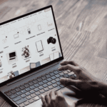 Hands typing on laptop viewing eCommerce site