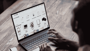 Hands typing on laptop viewing eCommerce site