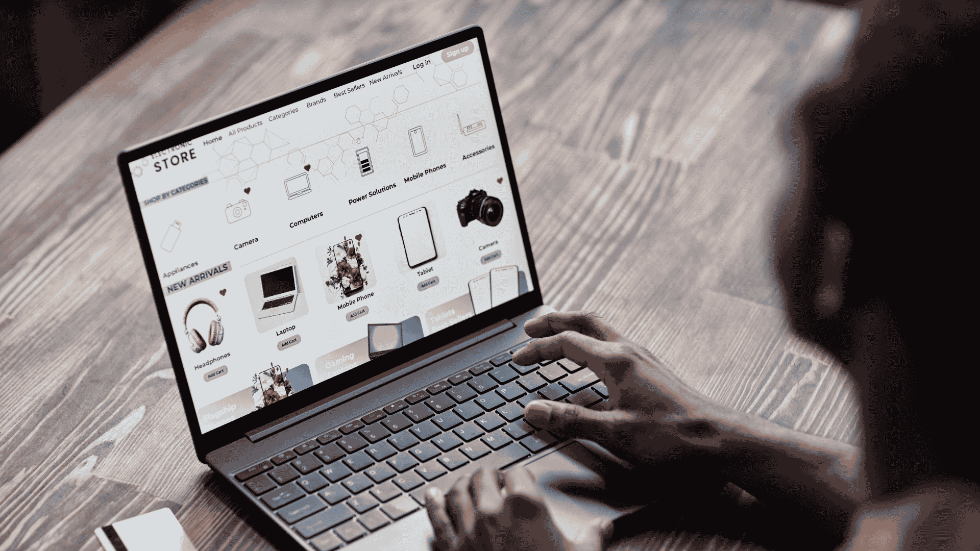 Hands typing on laptop viewing eCommerce site
