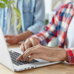 two men using laptop