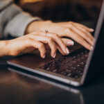 woman typing on laptop