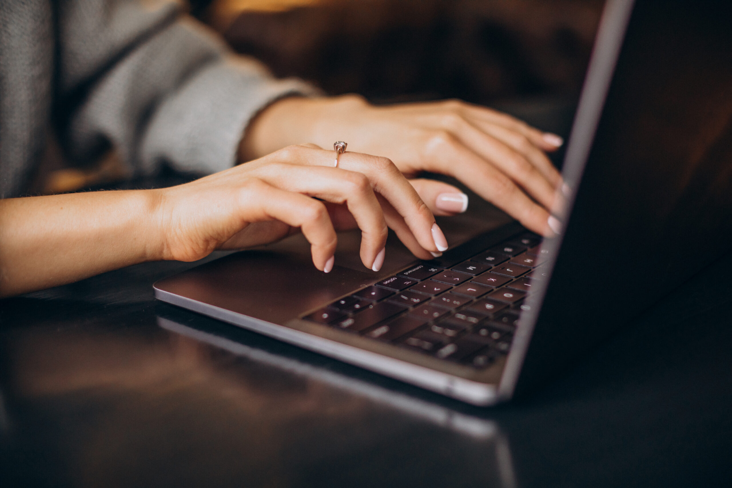 woman typing on laptop