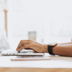 man typing on laptop