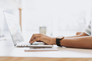 man typing on laptop