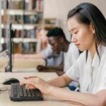 woman typing on computer