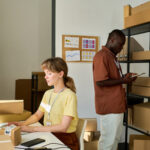warehouse workers typing on computer